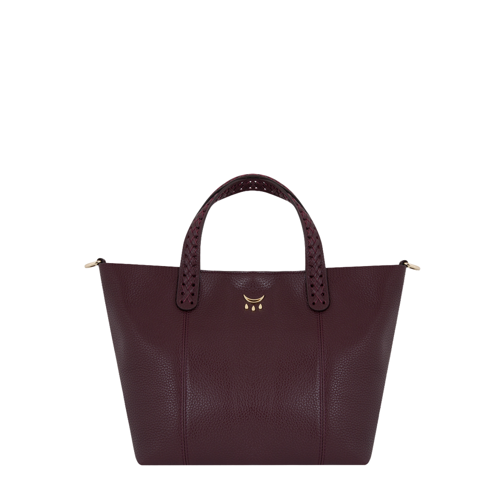 Burgundy leather handbag with gold accents on a white background